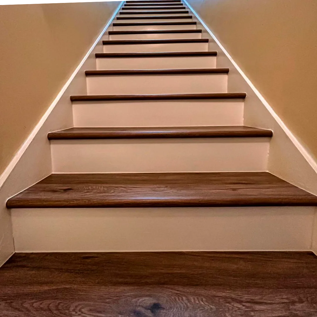 Custom white risers with dark wood stair treads in farmhouse style