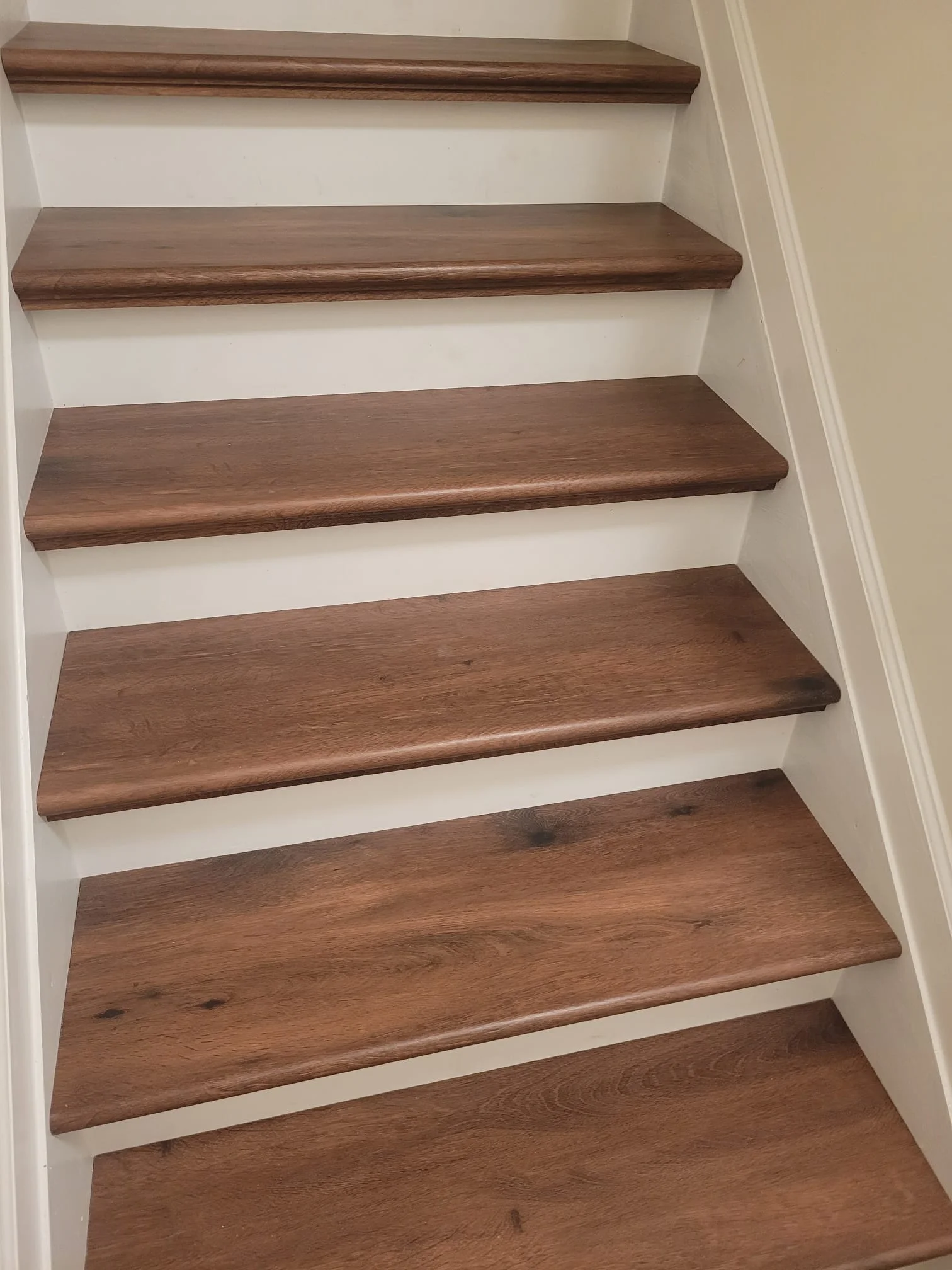 Detailed view of new wood stair treads and white risers